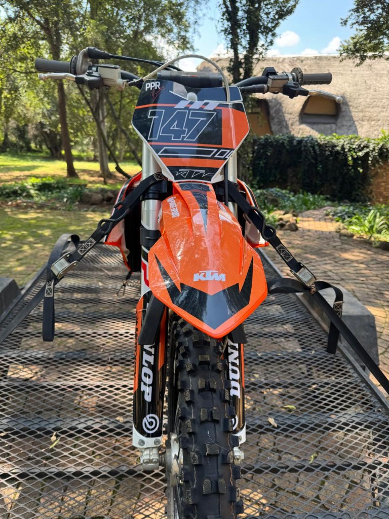 KTM #147 front number plate graphics by Plan Photo Repro