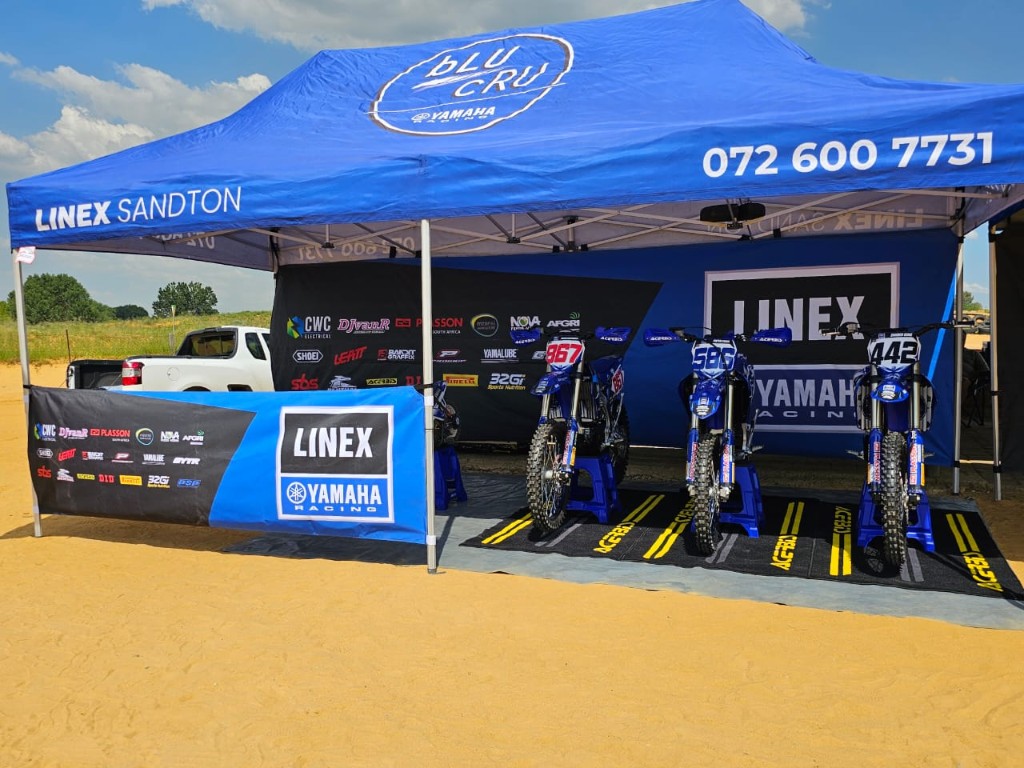 Linex Sandton Yamaha Racing branded event gazebo with three motocross bikes, bLU cRU banners and sponsor backdrops by Plan Photo Repro